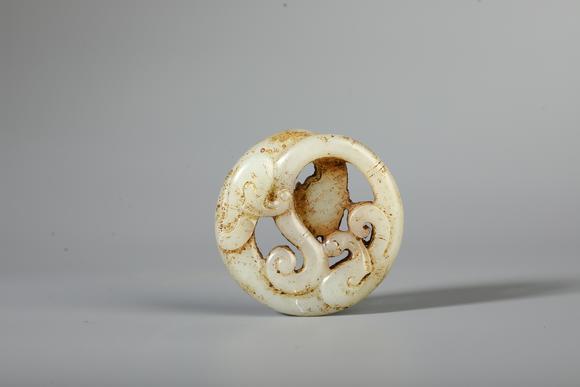 SEAVIEW AUCTIONS PTY LTDA Pale White Jade Openwork Circular Chilong Pendant, China, 2nd BCE–2nd CE