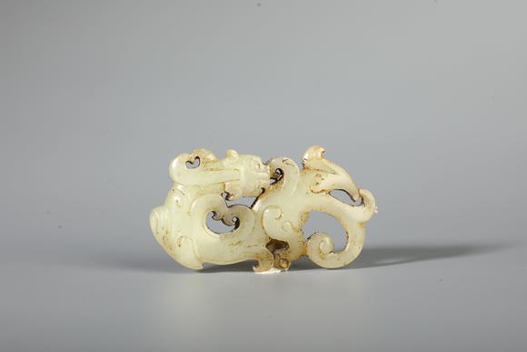 SEAVIEW AUCTIONS PTY LTDA Pale White Jade Openwork Coiled Dragon Pendant, China, 2nd BCE–2nd CE