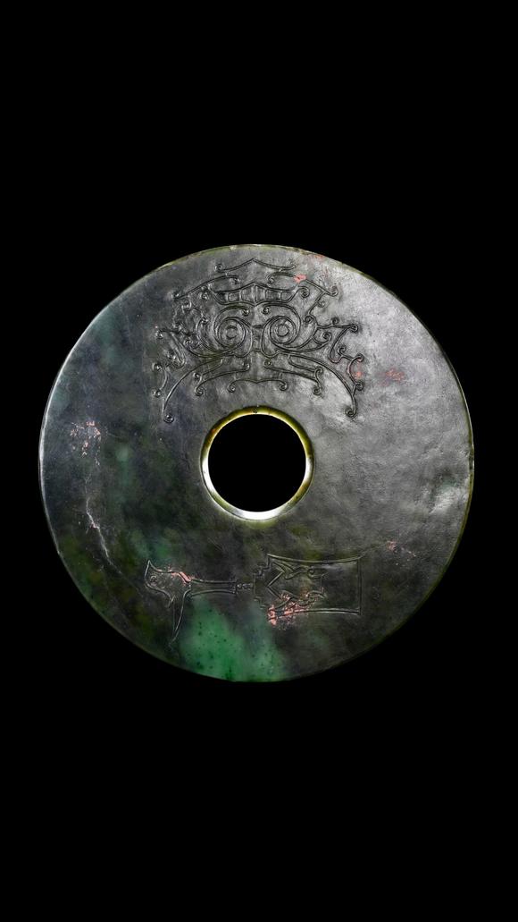 Castle AuctionA Dark Green Jade Bi Disc with Incised Decoration, Neolithic, Circa 3300–2300 C BC Pr.