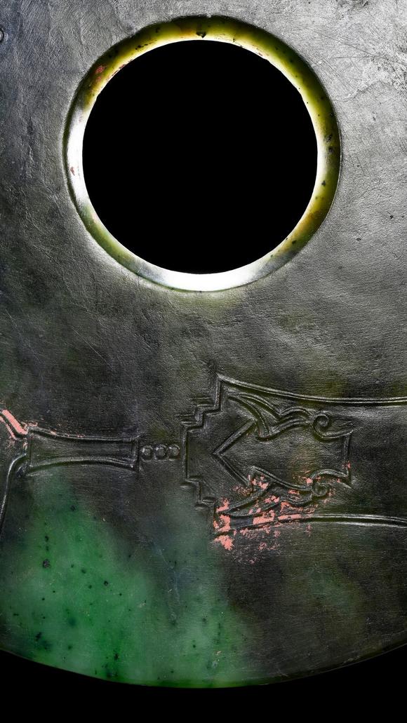 Castle AuctionA Dark Green Jade Bi Disc with Incised Decoration, Neolithic, Circa 3300–2300 C BC Pr.