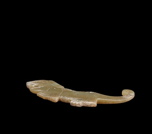 Castle AuctionA Calcified Yellow Jade Tiger-form Pendant, Western Zhou, Circa 10th–9th C BC Pr.