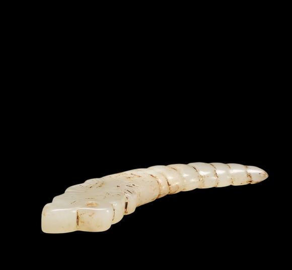 Castle AuctionA White Jade Silkworm Pendant with Russet Veins, Western Zhou, Circa 10th–8th C BC Pr.