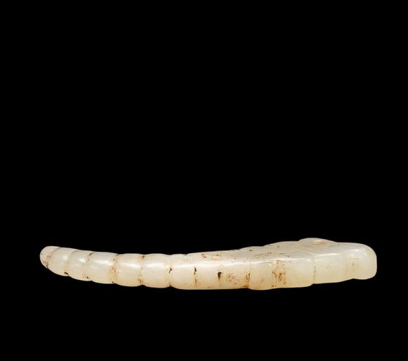 Castle AuctionA White Jade Silkworm Pendant with Russet Veins, Western Zhou, Circa 10th–8th C BC Pr.