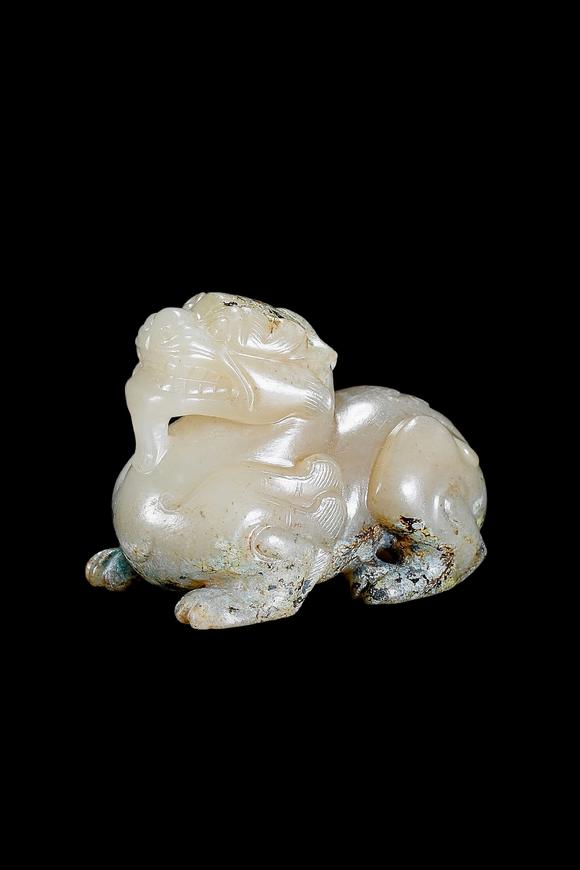 Castle AuctionA Pale Celadon Jade Mythical Beast Carving, Han, Circa 2nd C BC–2nd C AD Pr.