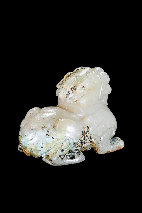 Castle AuctionA Pale Celadon Jade Mythical Beast Carving, Han, Circa 2nd C BC–2nd C AD Pr.