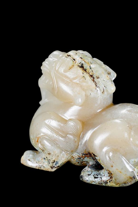 Castle AuctionA Pale Celadon Jade Mythical Beast Carving, Han, Circa 2nd C BC–2nd C AD Pr.