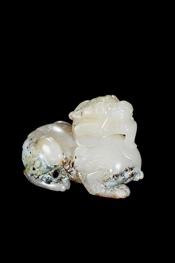 Castle AuctionA Pale Celadon Jade Mythical Beast Carving, Han, Circa 2nd C BC–2nd C AD Pr.
