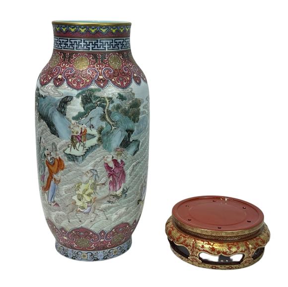 Castle AuctionA Chinese Rouge Famille Rose vase adorned with the Eight Immortals' figures pattern, together with A Chinese porcelain stand, Qian Long Pr. 