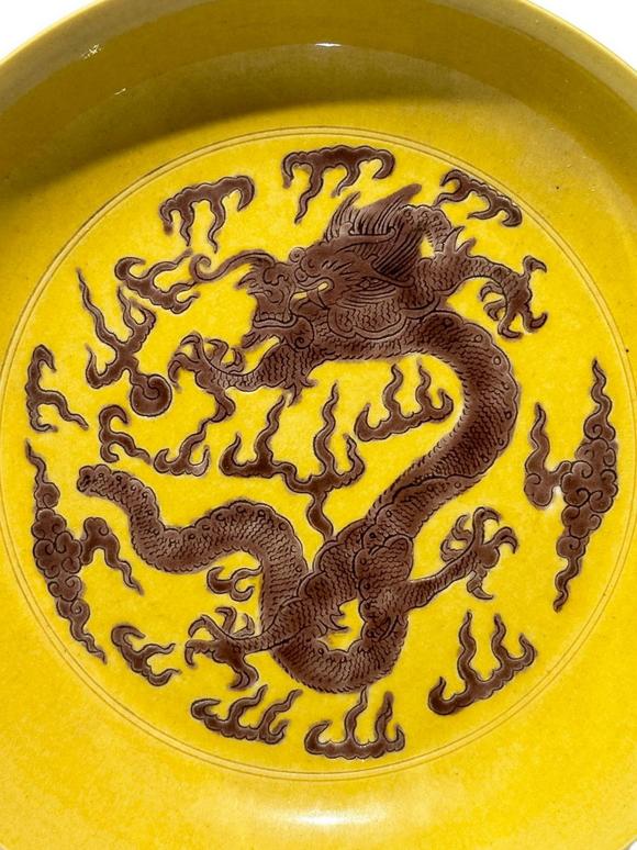 Castle AuctionYellow ground with purple dragon patterns dish, Kang Xi Pr. 