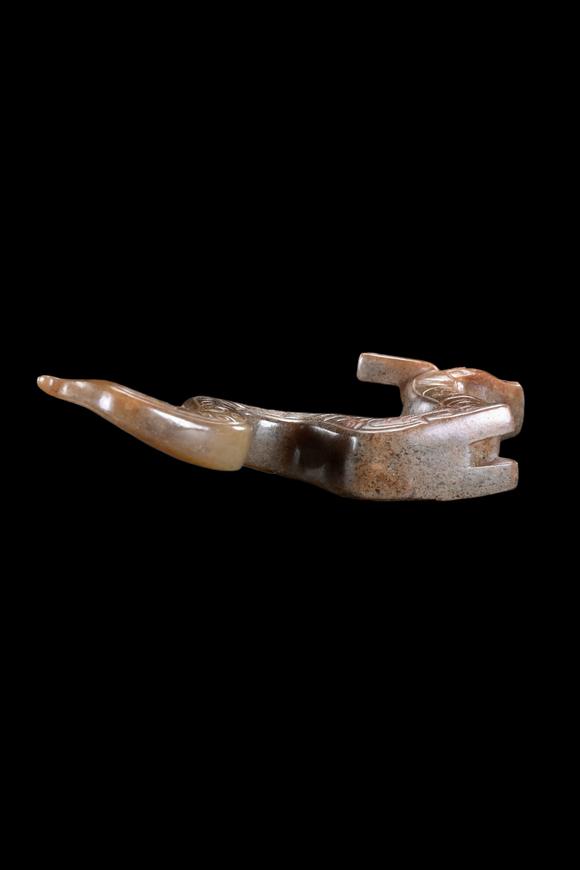 Castle AuctionA Calcified Brown Jade Dragon Pendant, Han, Circa 2nd C BC–2nd C AD Pr.
