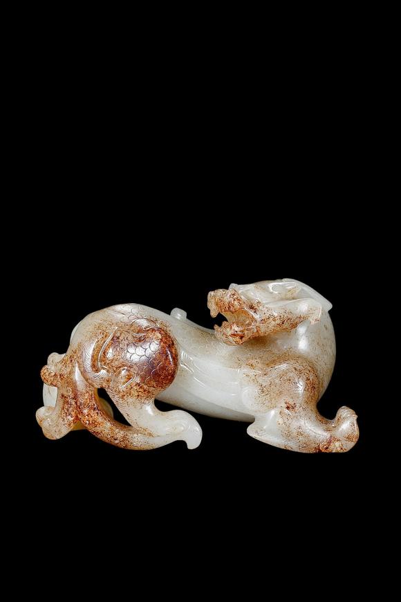 Castle AuctionA White Jade Mythical Beast Carving with Russet Inclusions, Han, Circa 2nd C BC–2nd C AD Pr.