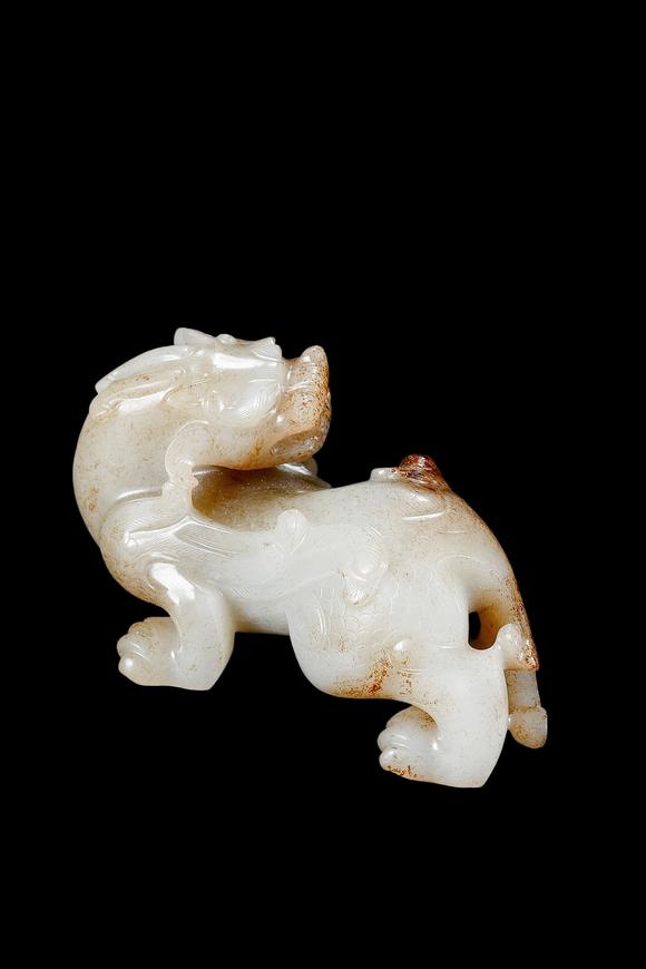 Castle AuctionA White Jade Mythical Beast Carving with Russet Inclusions, Han, Circa 2nd C BC–2nd C AD Pr.