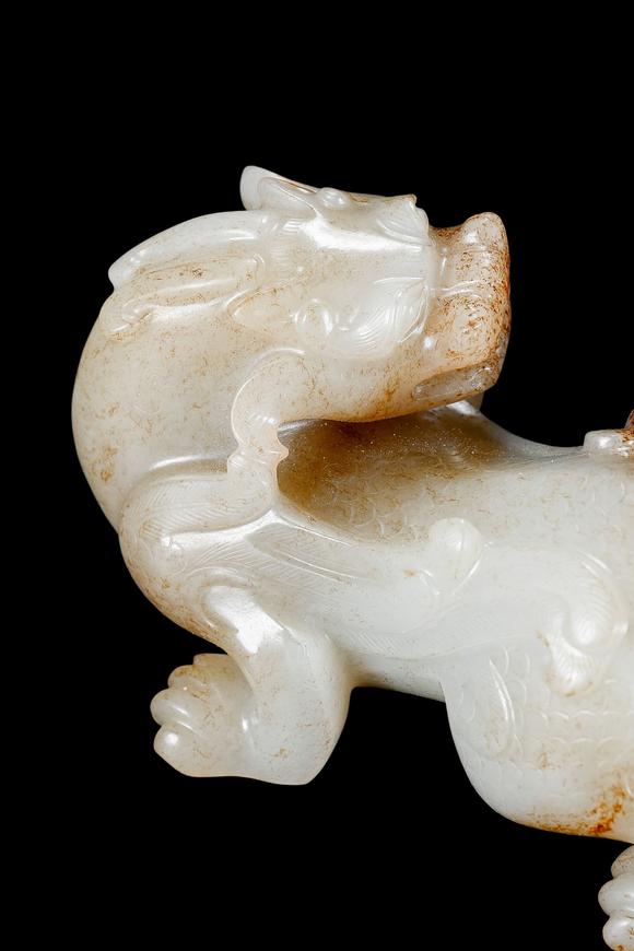 Castle AuctionA White Jade Mythical Beast Carving with Russet Inclusions, Han, Circa 2nd C BC–2nd C AD Pr.