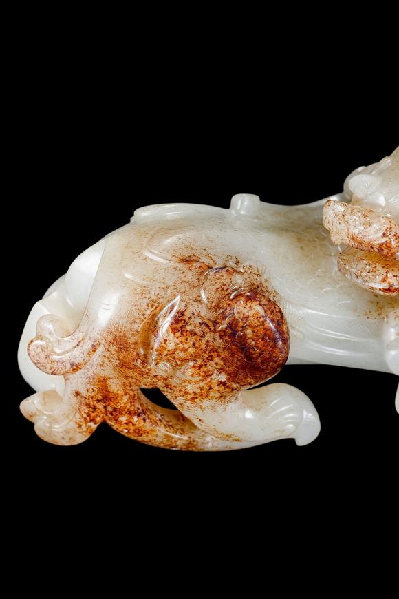 Castle AuctionA White Jade Mythical Beast Carving with Russet Inclusions, Han, Circa 2nd C BC–2nd C AD Pr.