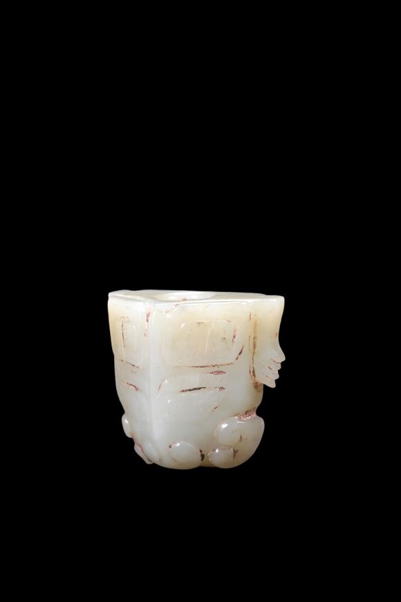 Castle AuctionA Pale Celadon Jade Taotie Mask Bead, Shang, Circa 13th–11th C BC Pr.