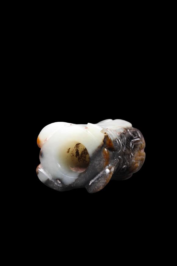 Castle AuctionA Mottled Black & Brown Jade Flared Taotie Bead, Shang, Circa 13th–11th C BC Pr.