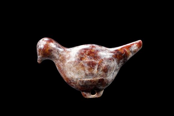 Castle AuctionA Mottled Reddish Brown Jade Bird Carving, Liangzhu, Circa 3300–2300 C BC Pr.