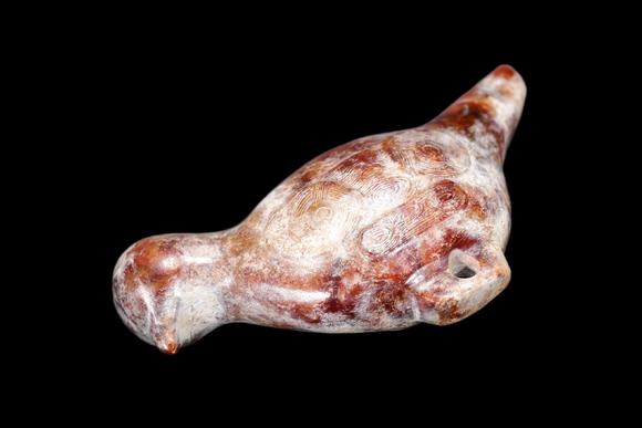 Castle AuctionA Mottled Reddish Brown Jade Bird Carving, Liangzhu, Circa 3300–2300 C BC Pr.