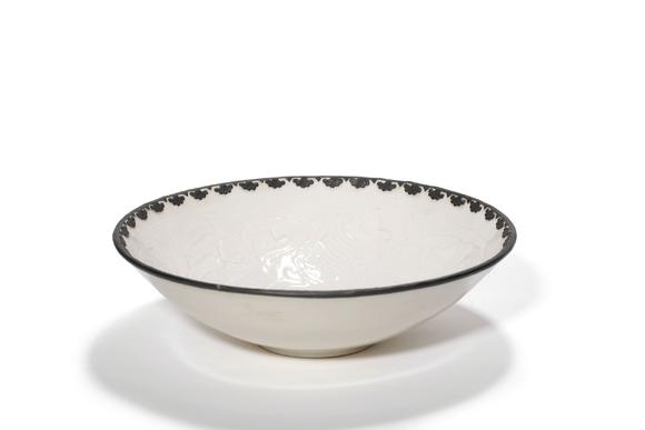 Castle AuctionA Ding Kiln Carved Floral Bowl with Metal Rim, 10th–12th C Pr.
