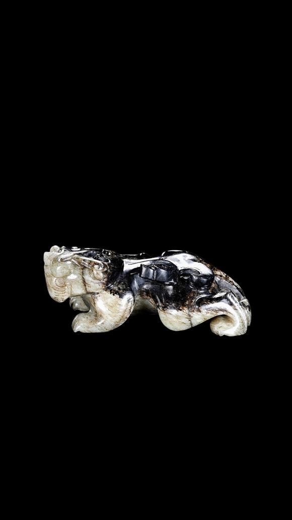 Castle AuctionA Mottled Black & White Jade Crouching Tiger Carving, Han, Circa 2nd C BC–2nd C AD Pr.