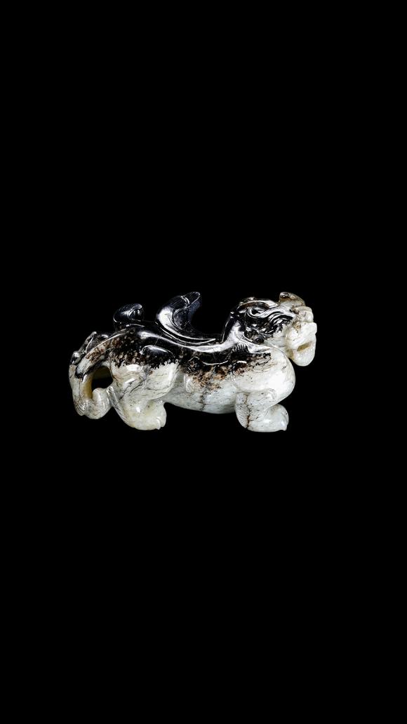 Castle AuctionA Mottled Black & White Jade Crouching Tiger Carving, Han, Circa 2nd C BC–2nd C AD Pr.