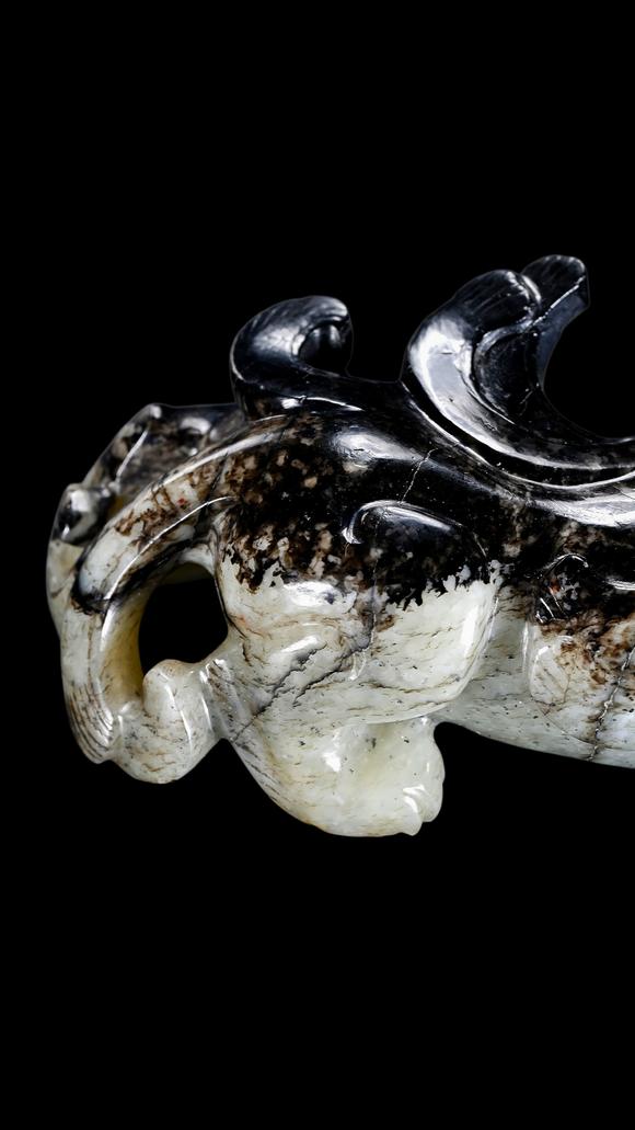 Castle AuctionA Mottled Black & White Jade Crouching Tiger Carving, Han, Circa 2nd C BC–2nd C AD Pr.