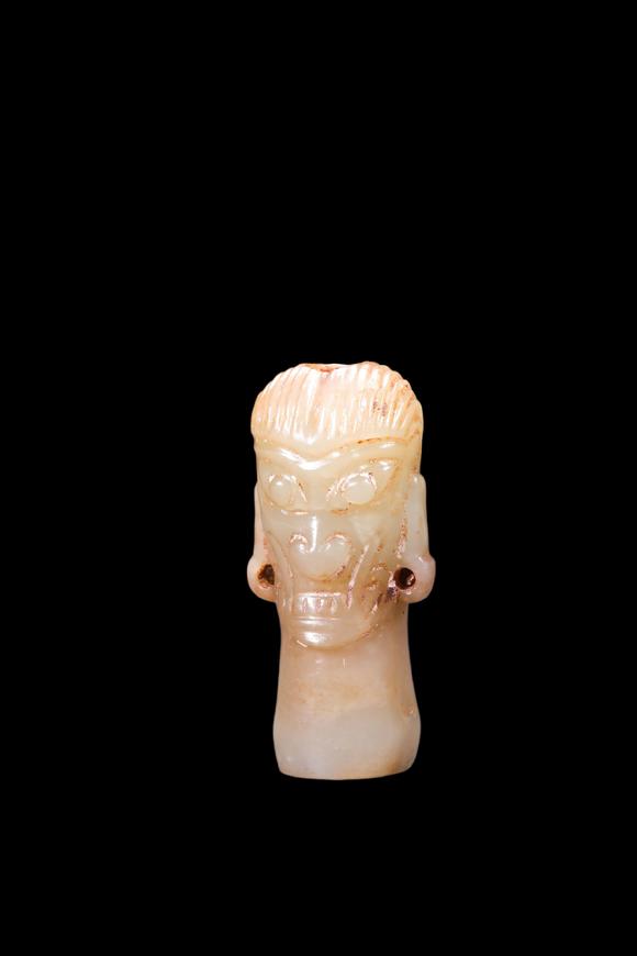 Castle AuctionA Pale Jade Human Head Bead with Russet Inclusions, Shang, Circa 13th–11th C BC Pr.