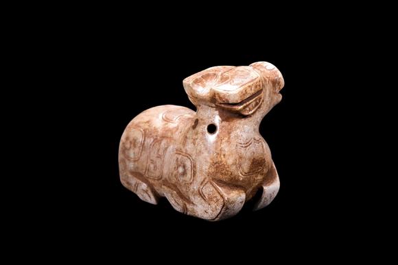 Castle AuctionA Calcified Pale Jade Recumbent Ox Carving, Shang, Circa 13th–11th C BC Pr.