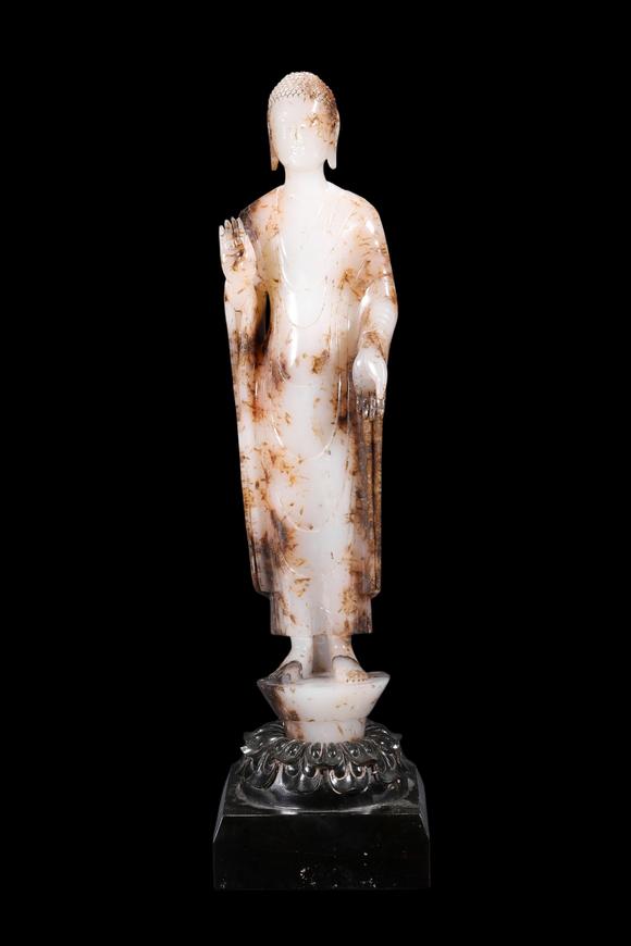Castle AuctionA White Jade Standing Buddha Statue with Russet Inclusions, Tang, Circa 618–907 AD Pr.