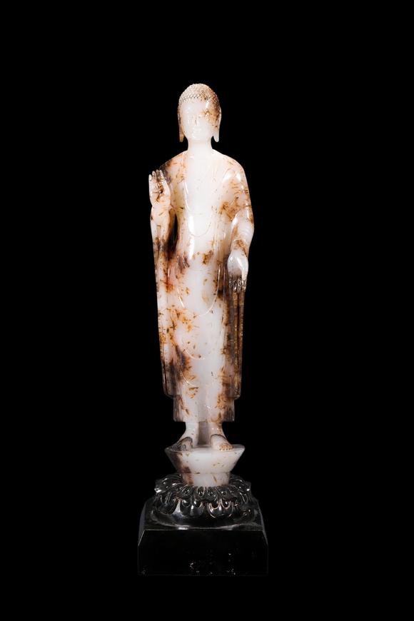 Castle AuctionA White Jade Standing Buddha Statue with Russet Inclusions, Tang, Circa 618–907 AD Pr.