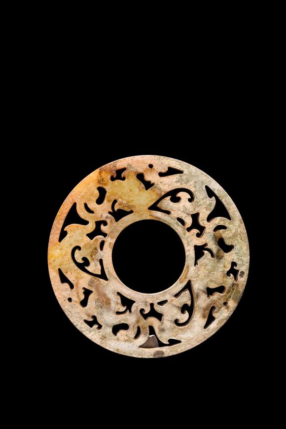 Castle AuctionA Calcified Yellow Jade Openwork Dragon Bi Disc, Han, Circa 2nd C BC–2nd C AD Pr.