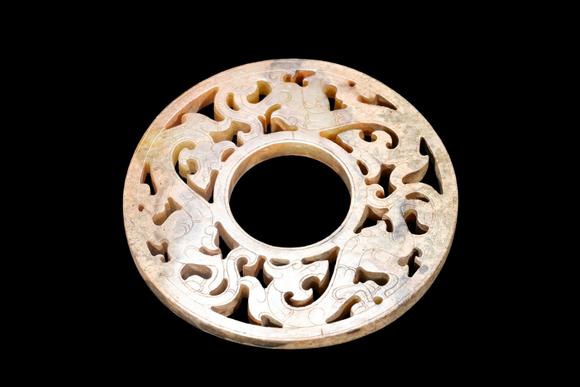 Castle AuctionA Calcified Yellow Jade Openwork Dragon Bi Disc, Han, Circa 2nd C BC–2nd C AD Pr.