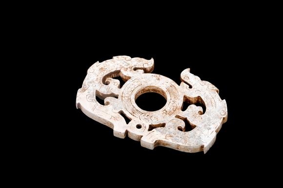 Castle AuctionA Calcified Pale Jade Twin Dragon Openwork Pendant, Han, Circa 2nd C BC–2nd C AD Pr.
