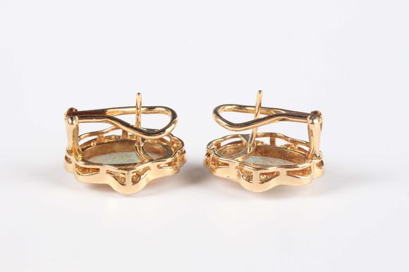 TooveysA pair of gold, opal and diamond shaped oval earrings, each collet set with the oval opal within a surround of tapered baguette and circular cut diamo