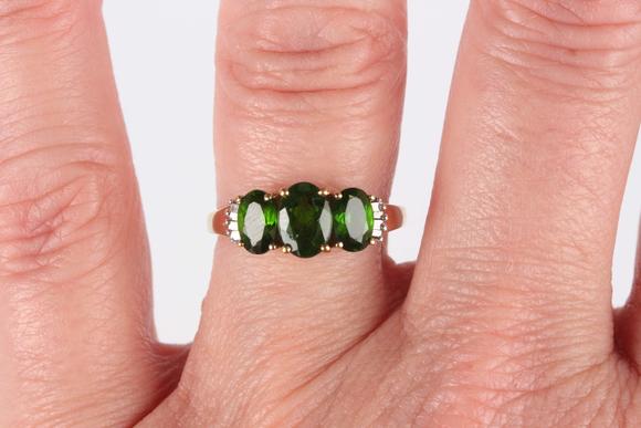 TooveysA 9ct gold ring, claw set with three oval cut green diopsides between baguette cut diamond set shoulders, ring size approx M, and a 9ct gold and colou