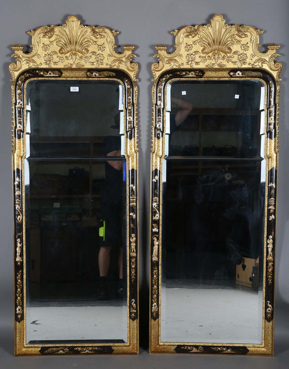 TooveysAn impressive pair of early 20th century Queen Anne style gilt and black japanned pier mirrors, each shaped crest with central shell and griffon heads