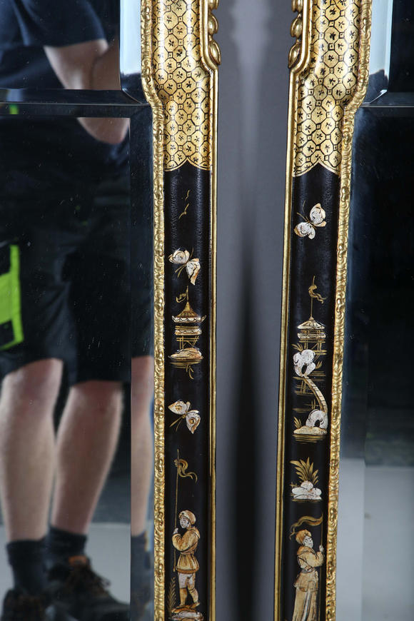 TooveysAn impressive pair of early 20th century Queen Anne style gilt and black japanned pier mirrors, each shaped crest with central shell and griffon heads