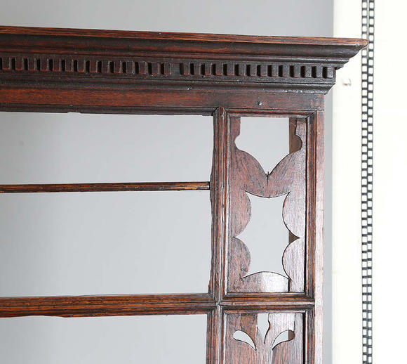 TooveysA good George III North Country oak dresser, the plate rack with pierced side panels above a lappet carved frieze and an arrangement of nine drawers,