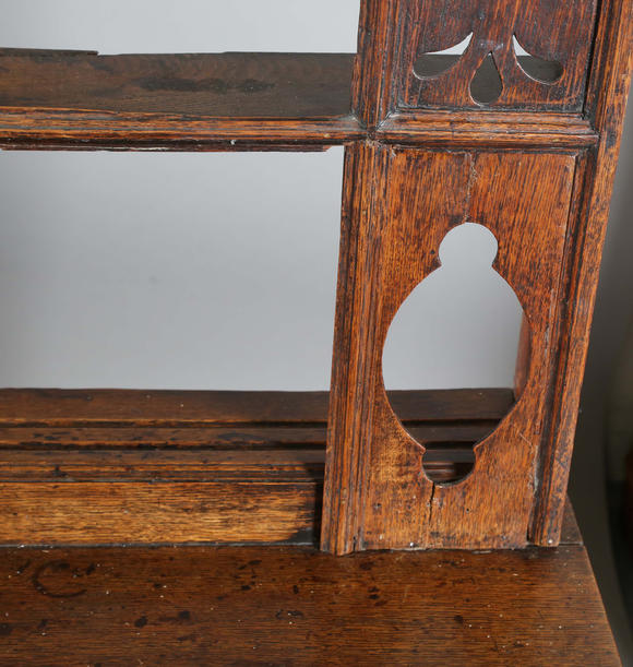 TooveysA good George III North Country oak dresser, the plate rack with pierced side panels above a lappet carved frieze and an arrangement of nine drawers,