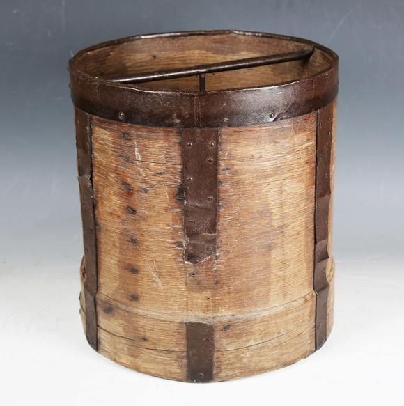 TooveysA 19th century French bentwood and metal bound grain measure, the underside stamped 'CORDIER', height 33cm, diameter 30cm.