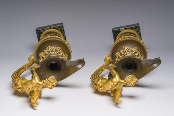 Coronari Auctions BVAn impressive pair of French Empire gilt and patinated bronze ewers on marble bases, attributed to Claude Galle, ca. 1800-1810