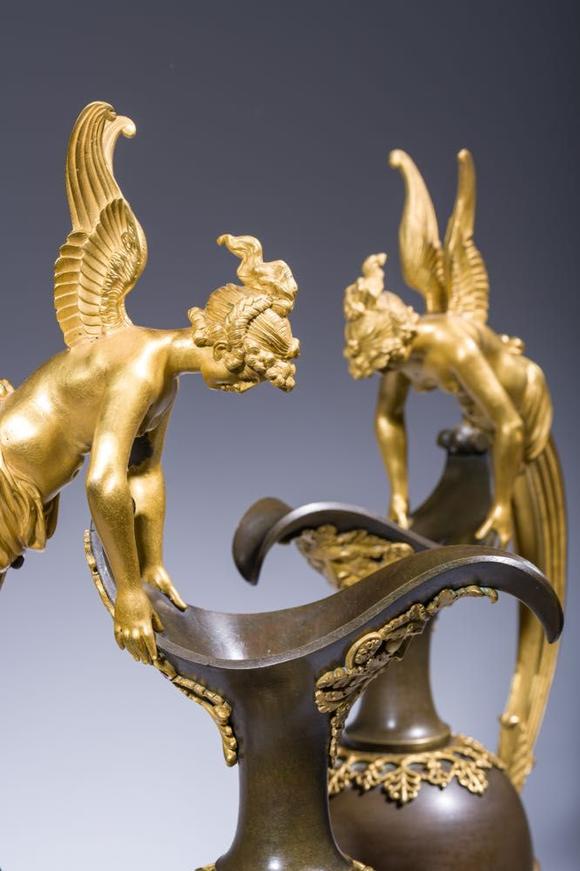 Coronari Auctions BVAn impressive pair of French Empire gilt and patinated bronze ewers on marble bases, attributed to Claude Galle, ca. 1800-1810
