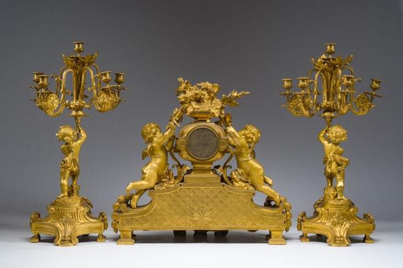 Coronari Auctions BVA fine and exceptional French Napoleon III gilt bronze three-piece clock garniture with putti and floral design, 19th C.