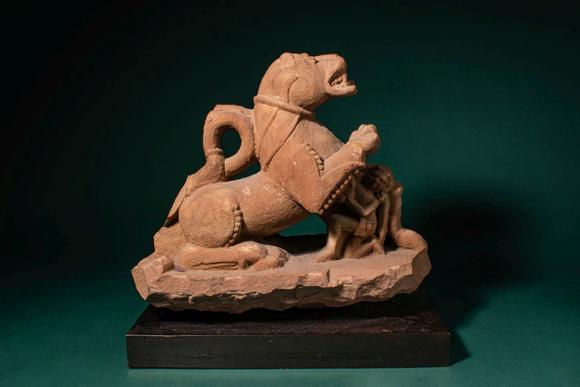 Apollo Art AuctionsCa. 11th - 12th century AD. >
A carved sandstone sculpture depicting a recumbent lion, shown with