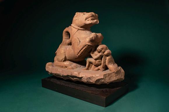 Apollo Art AuctionsCa. 11th - 12th century AD. >
A carved sandstone sculpture depicting a recumbent lion, shown with