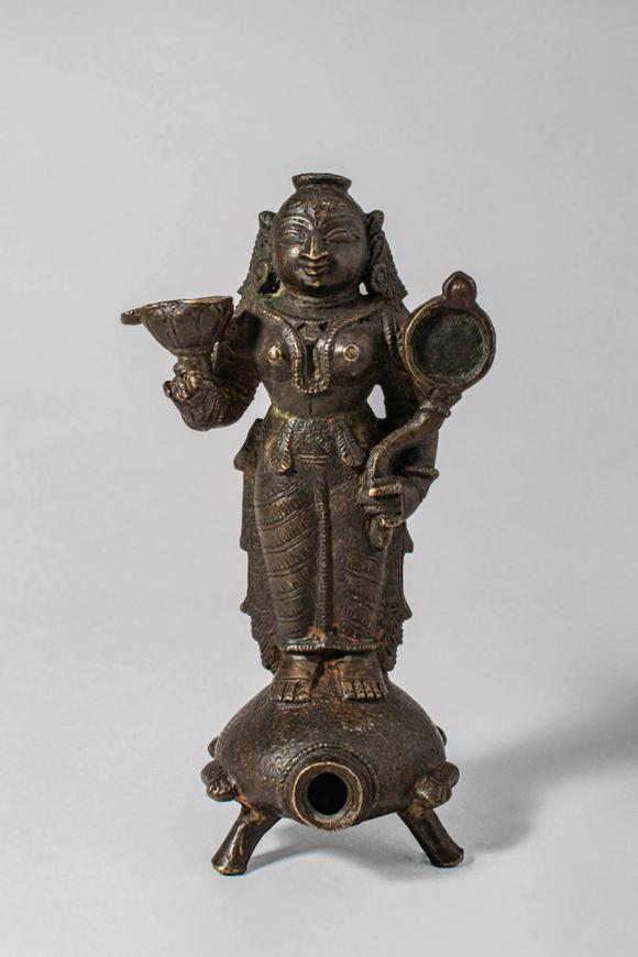 Apollo Art AuctionsCa. 14th-15th century AD. A bronze oil lamp cast in the form of Goddess Lakshmi, the consort of V