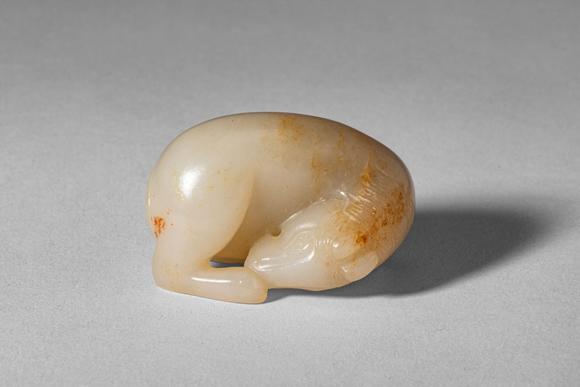 Apollo Art AuctionsMid Qing Dynasty, Ca. 18th century AD. >
A carved jade figure of a recumbent horse, depicted in a