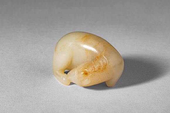 Apollo Art AuctionsMid Qing Dynasty, Ca. 18th century AD. >
A carved jade figure of a recumbent horse, depicted in a