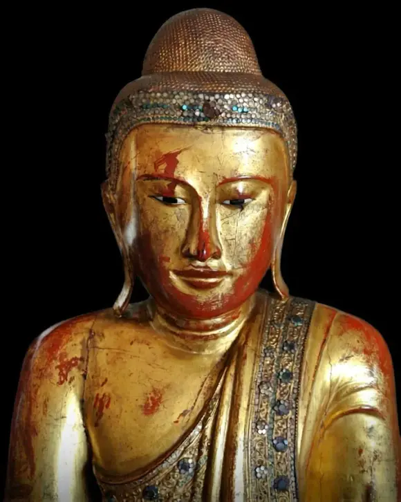Bertolami Fine ArtBuddha figure in the lotus position. Lacquered and gilded wood with stucco and glass paste applications, set on a wooden and black lacquer base. Burma, Mandalay, 19th century.