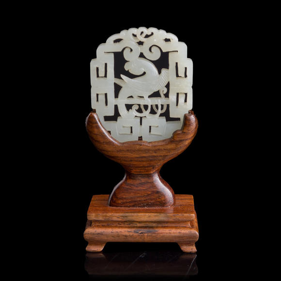Oakridge Auction Gallery十八世紀 白玉鏤雕鸚鵡佩（附木座）  A Chinese reticulated white jade 'parrot' plaque